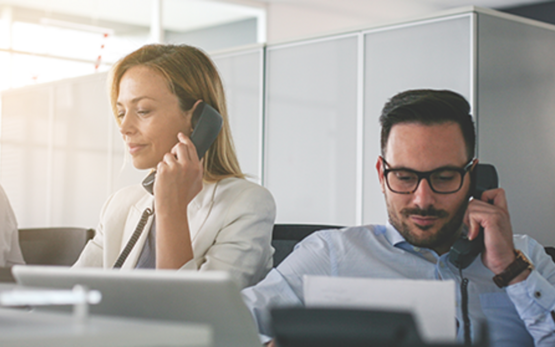 two people on phones