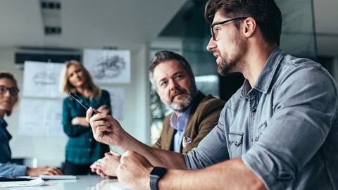 people sitting around a table discussing application issues