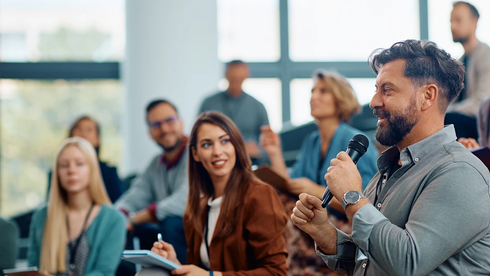 People doing Q&A at a conference