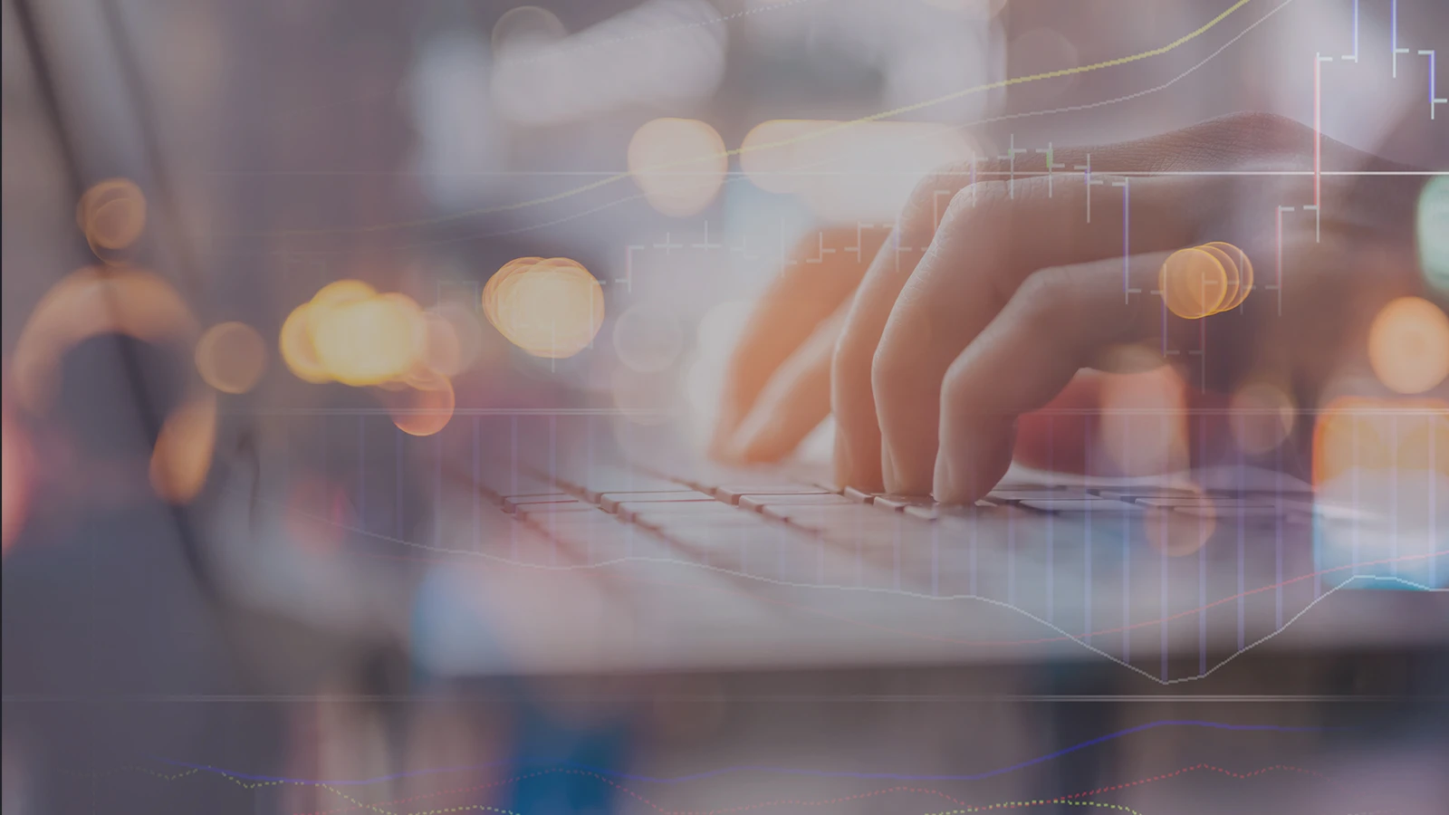 Obscured hands typing on laptop